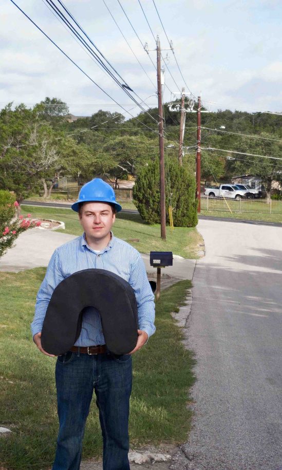 Image shows an engineer holding a 1 kilometer length of special fiber optic cable in the custom spool free cable coil geometry